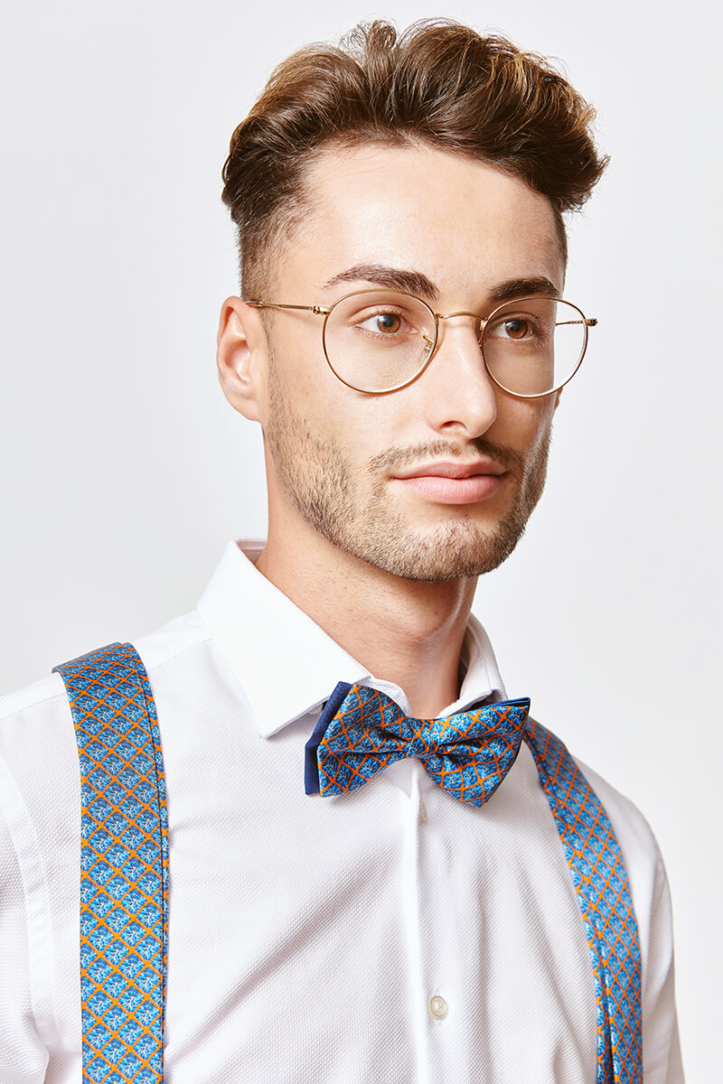 man with blue bowtie and blue suspenders