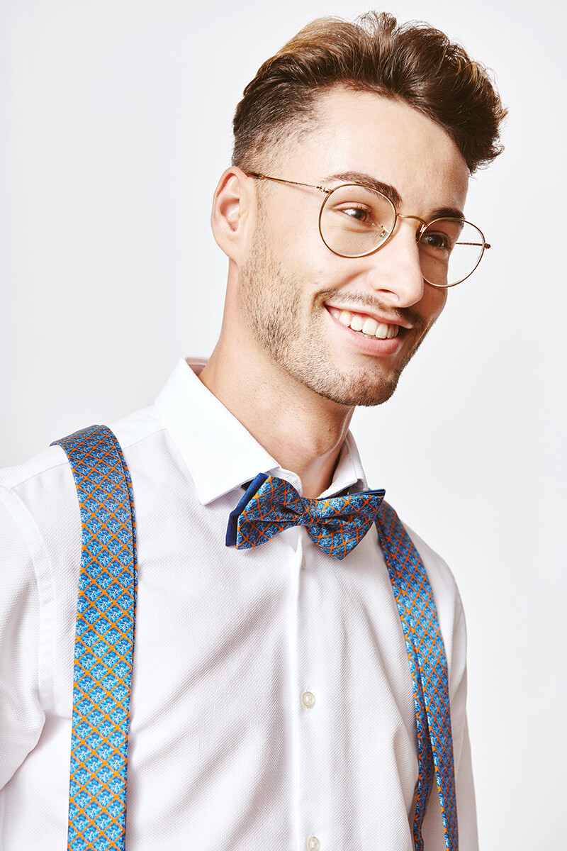 man with a blue bowtie and blue suspenders