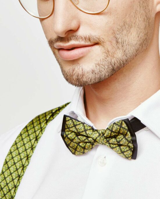man with a green bowtie and green suspenders
