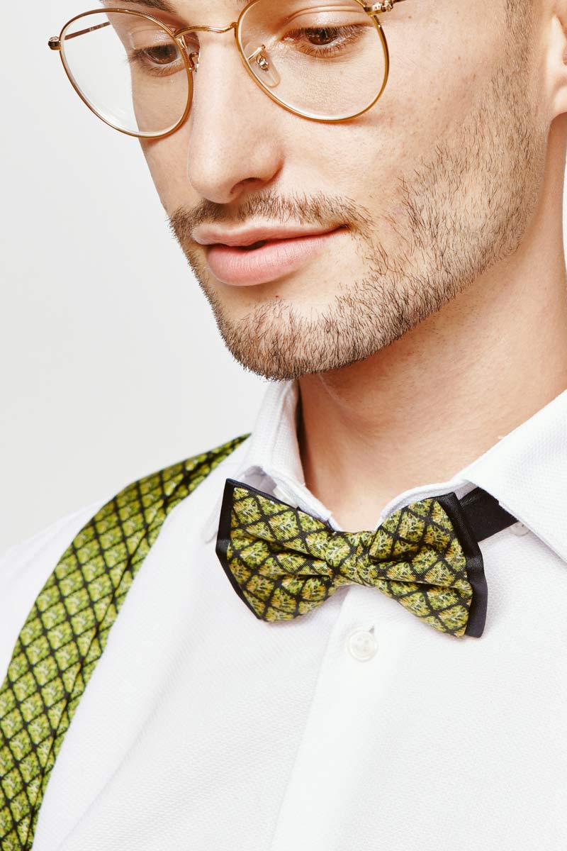 man with a green bowtie and green suspenders