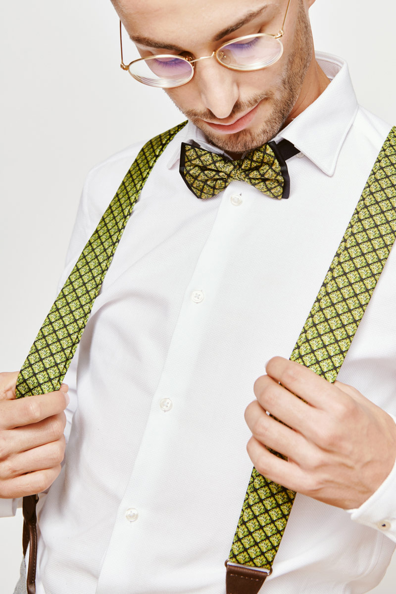 man with green suspenders and a green bowtie