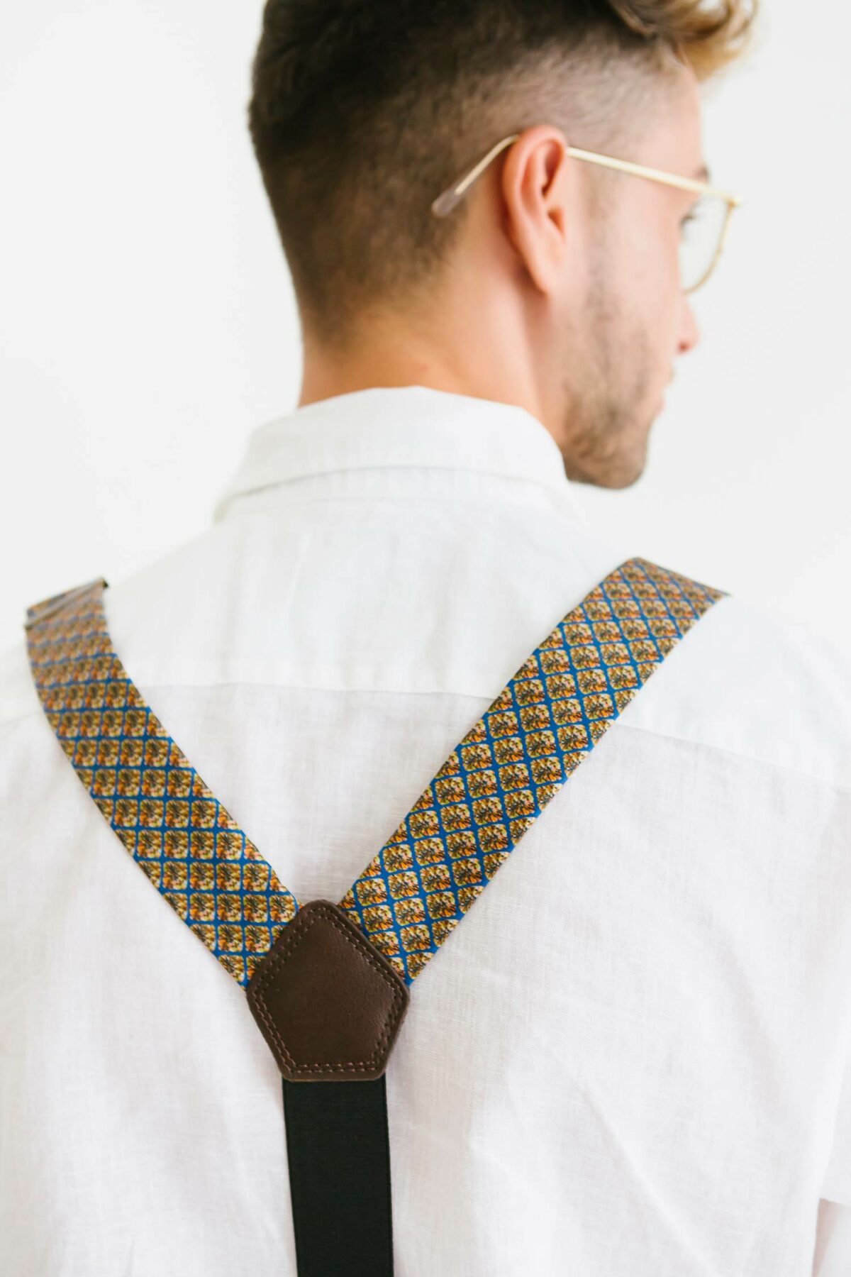 man with brown suspenders