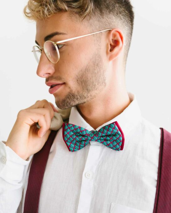 man with bordeaux red suspenders and a blue bowtie
