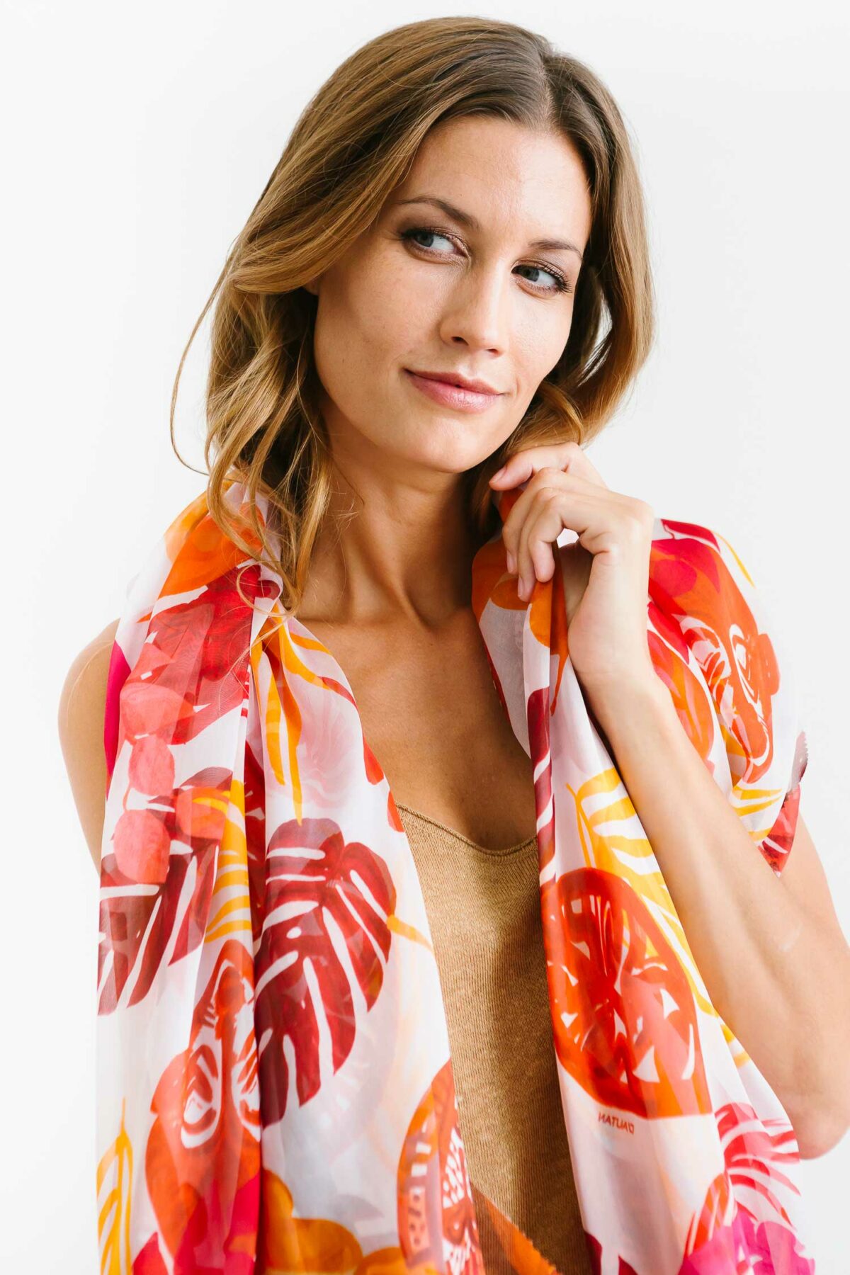 woman with an orange red pink and white scarf