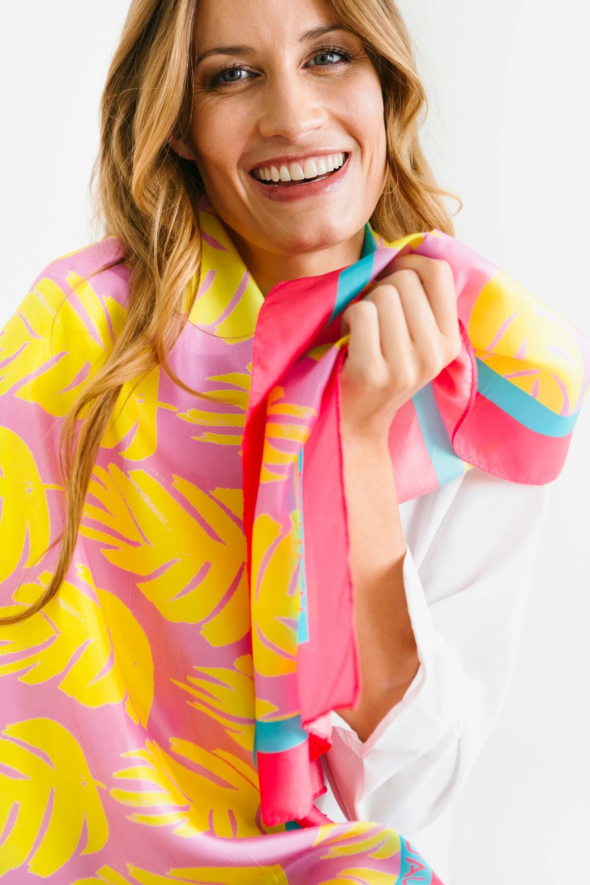 laughing woman wearing a colourful scarf