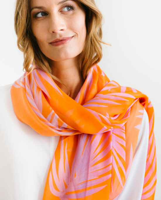 woman wearing an orange and pink scarf on her neck