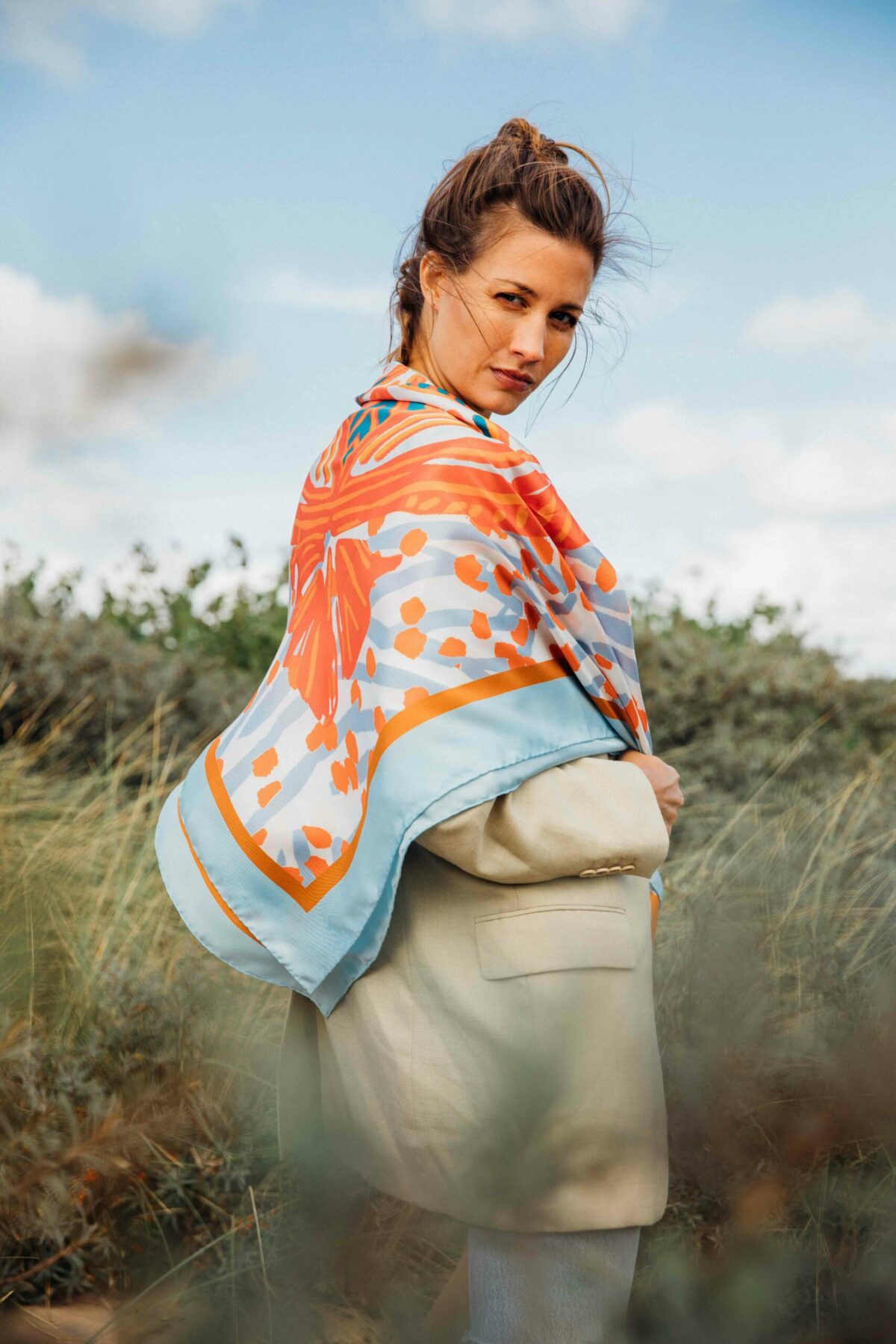 woman wearing an orange and blue scarf on her back